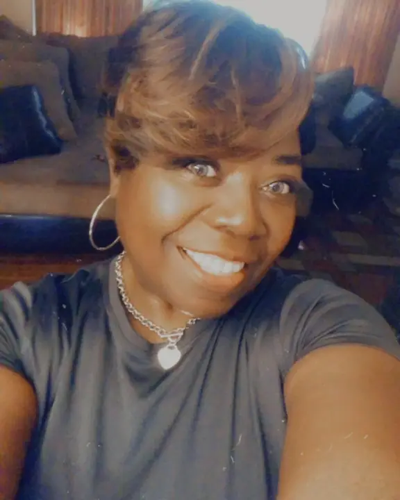 Mrs Betty White Jackson with short hair and necklace.