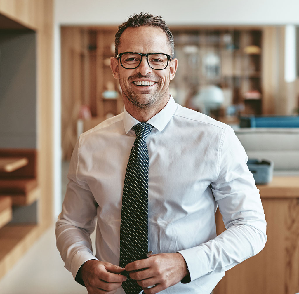 smiling mature businessman standing alone